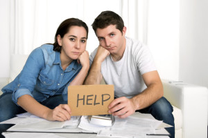 young couple worried at home in bad financial situation stress